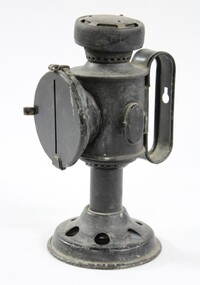 Side view of a black painted metal signal lamp.