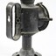 Back view of a black painted metal signal lamp with a elongated oval handle.