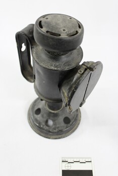 Top view of a black painted metal signal lamp.