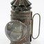Black painted metal signal lamp with a clear glass lens.