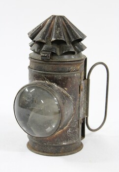 Black painted metal signal lamp with a clear glass lens.