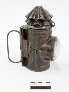 Black painted metal signal lamp with a clear glass lens.