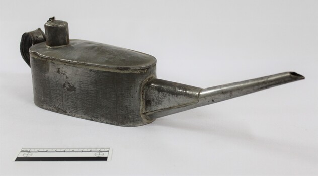 Metal container with a long spout and scale.