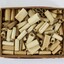Dozens of small paper scrolls with bible verses printed on them stored inside a small cardboard box 