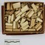 Dozens of small paper scrolls with bible verses printed on them stored inside a small cardboard box with 5cm scale