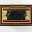 Birds eye view of Chad Valley Money Tin c. 1930s-1950s, small black tin with handle and coin slot on lid