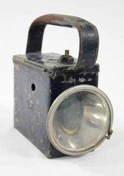 Front view of a rectangular metal lamp.