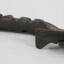 Underside of a dark brown cast iron can opener