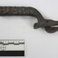 Dark brown cast iron can opener with the word 'GUARD' in raised letters on the side of the handle.