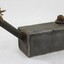 Rectangular grey metal lamp with a textile fibre wick.
