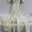 A floor length white satin wedding dress with structured sleeves and studded diamantes 