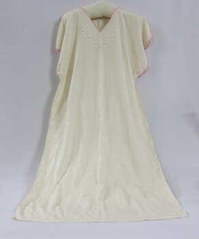 A white silk nightdress with pink embroidery around the collar and sleeves