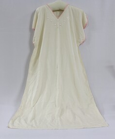 A white silk nightdress with pink embroidery around the collar and sleeves