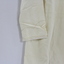 Close up of embroidered sleeve of silk nightdress. 
