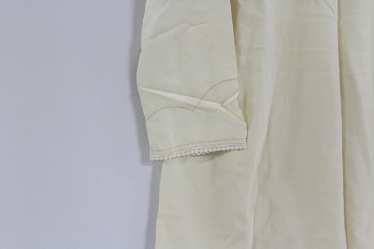 Close up of embroidered sleeve of silk nightdress. 