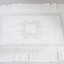 A handmade white pillow sham with needlework