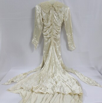 A silk wedding dress with fitted bodice and lace collar