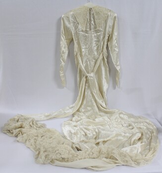 A silk wedding dress with fitted bodice and lace collar
