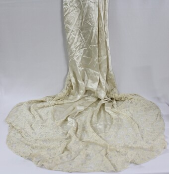 A silk wedding dress with fitted bodice and lace collar