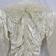 A silk wedding dress with fitted bodice and lace collar
