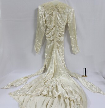 A silk wedding dress with fitted bodice and lace collar