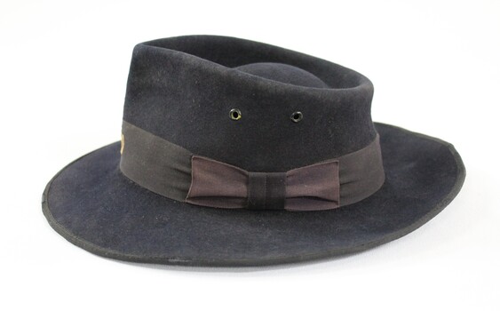 Sde of a dark blue/grey felt Victorian Railways hat.