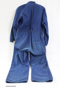 Back of blue Victorian Railways work coveralls, with a black and white 5 cm scale.