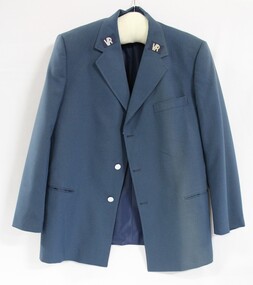 Front of a blue Victorian Railways jacket, with the VR logo stitched on each lapel and silver buttons.