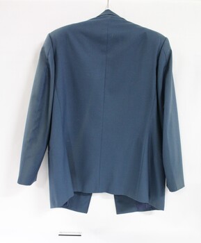 Back of a blue Victorian Railways jacket, with a black and white 10 cm scale below the jacket.