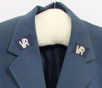 Two Victorian Railways VR logos on the lapels of a blue jacket.