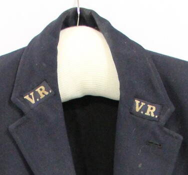 Close up of the Victorian Railways "V.R." logo stitched to each lapel.