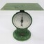 Front view of the green painted cast iron scales with a flat rectangular surface for weighing up to 25 kg.