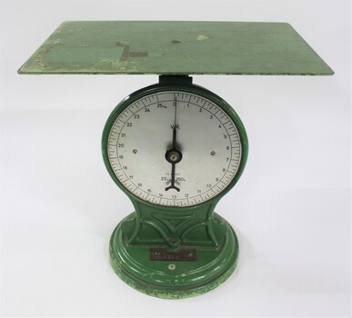 Front view of the green painted cast iron scales with a flat rectangular surface for weighing up to 25 kg.