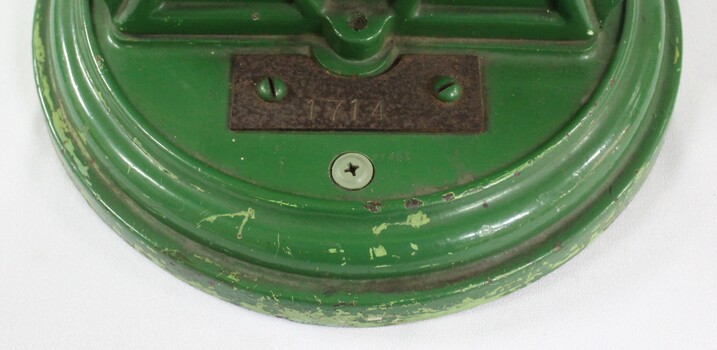 Small iron plate on base of scales.  