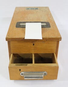 A wooden money till from Stiff and Gannon in Wodonga with 2 lockable drawers with metal handle and invoice slot.