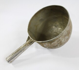 Large aluminium scoop with a handle soldered on one side edge. 