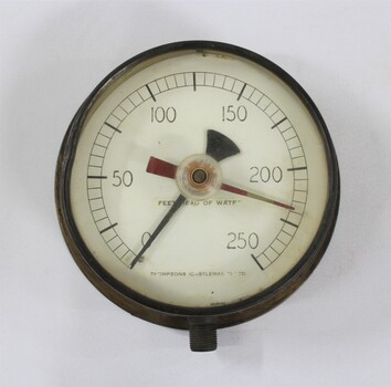 Metal and glass water pump pressure gauge, with the inscritption "FEET HEAD OF WATER / THOMPSONS (CASTLEMAI-- LTD".