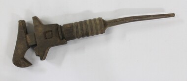 Large cast iron shifter wrench with an adjustable grip.e.