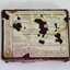 A burgundy coloured cardboard box with technical and manufacturers information printed on white paper on lid 
