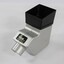 A box shaped silver and black plastic magnifier with eye piece