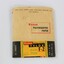 A paper packet coloured light tan, black green, yellow and red, containing Kodak photographic paper.