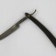 An open cut throat razor with black plastic handle