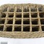 Rectangular wicker crate for delivering bottled drinks with 12 compartments and handles at each narrow end, and a black and white 10 cm scale in the foreground.