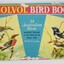 A rectangular book with illustrations of four birds on a blue front cover, with title text 