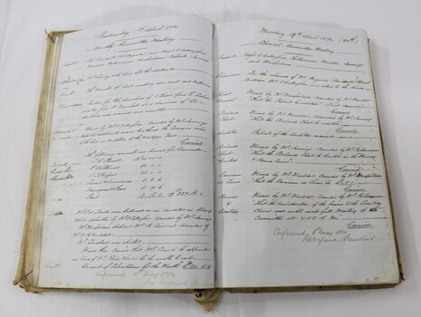 Inside of minute book showing hand written record of regular meetings. Some typed reports also included.