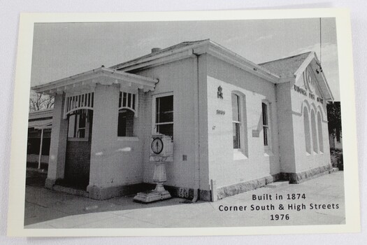 Black and white photograph of a single story white building built c.1874