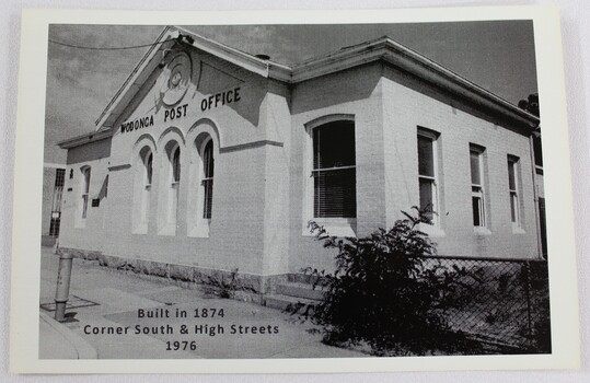 Black and white photograph of a single story white building built c.1874