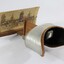 Side view of a stereoscope with a cardboard 'view' of a streetscape 