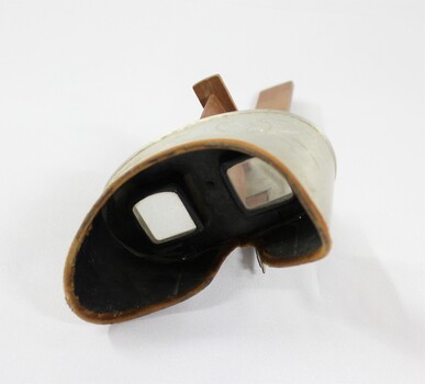 Eyepiece of a stereoscope with cardboard 'view' of a streetscape