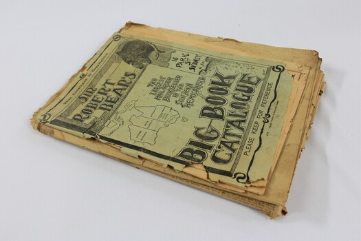 A stack of newspapers and a book catalogue 